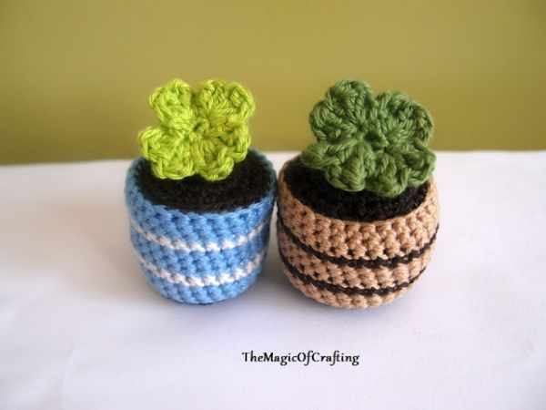 Two crochet plants in little crochet plant pots.