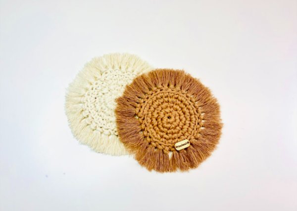 Boho-style crochet coasters with fringing.