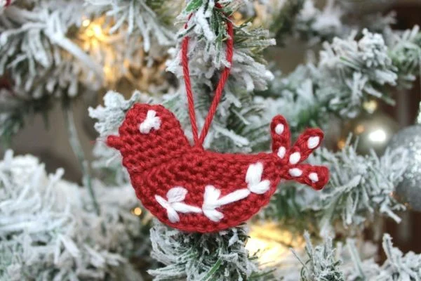 A red and white crochet dove ornament.
