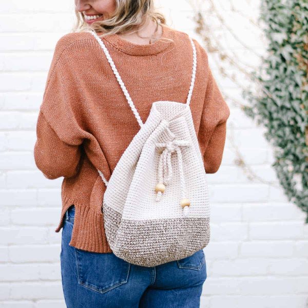 A two-toned crochet drawstring backpack.