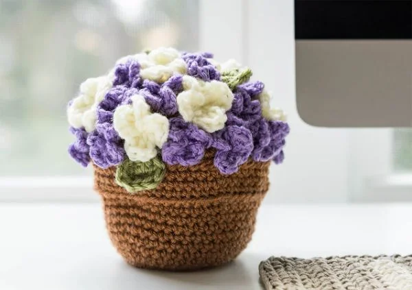 A little crochet plant pot with crochet hydrangeas.