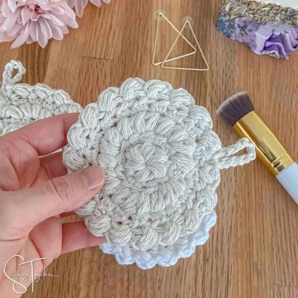 Lacy crochet makeup remover pads with a little loop for hanging.