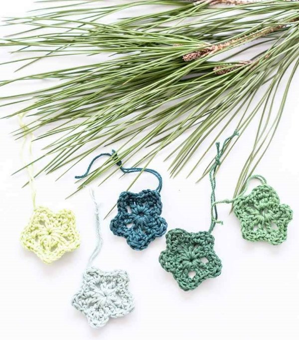 A crochet star garland and pine needles.