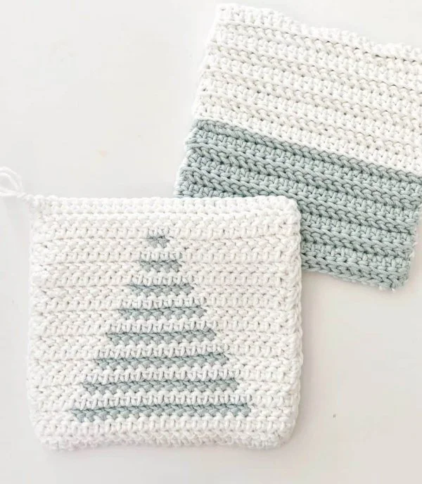 Two green and white crochet trivets.