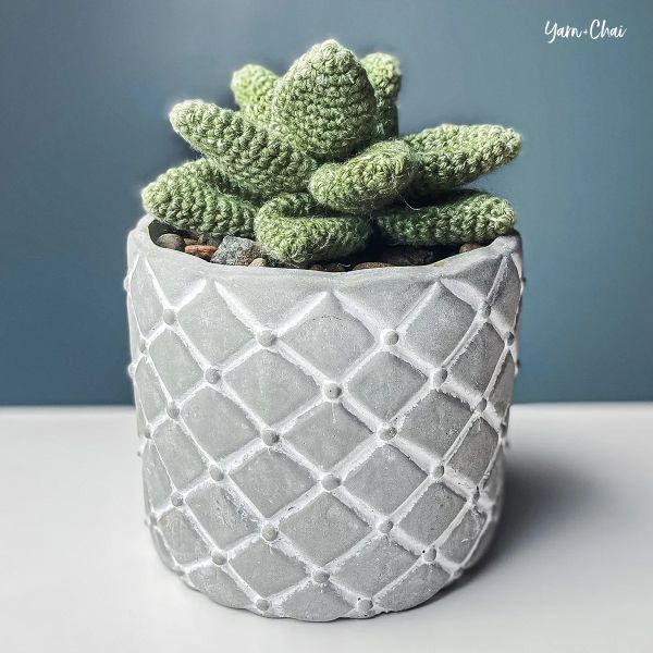 A realistic looking crochet succulent in a pot.