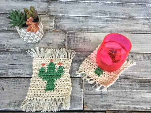 Crochet coasters with cactus motifs and a bright pink cup.