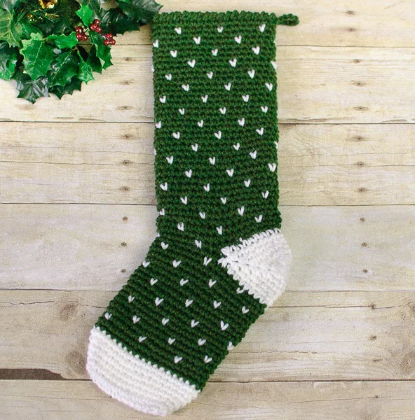Forest green and white colourwork crochet stocking.
