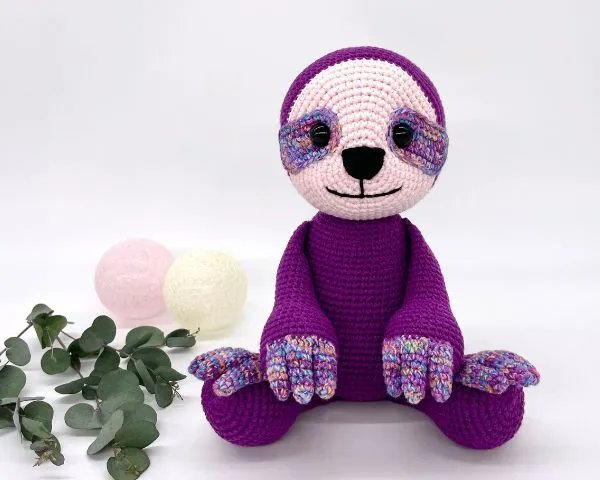 A purple crochet sloth.