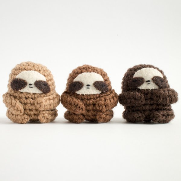 Three mini crochet sloths.