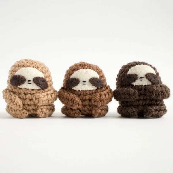 Three mini crochet sloths.