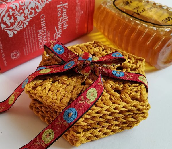 A stack of mustard yellow coasters tied with a ribbon.