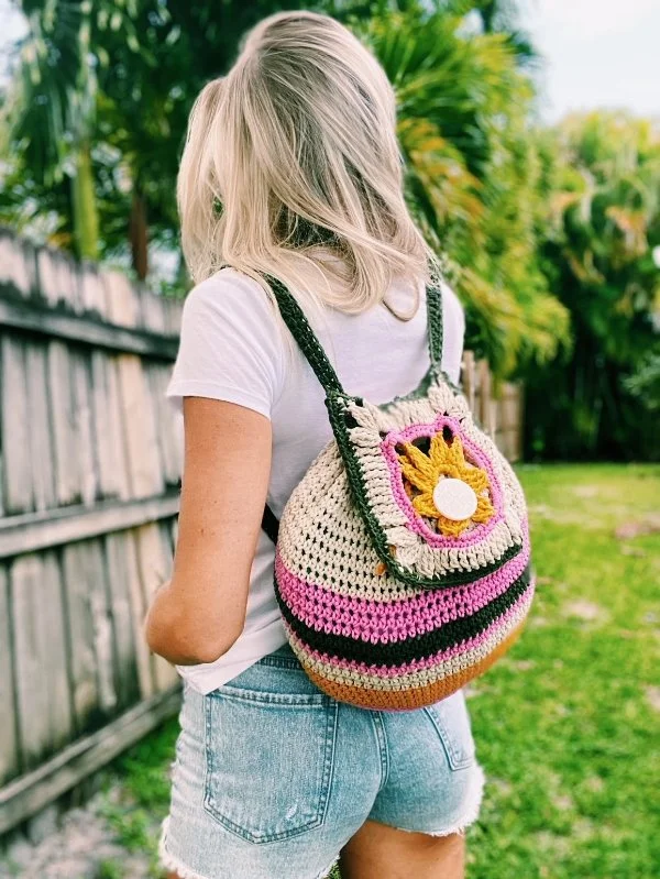 A woman with a brightly coloured backpack.
