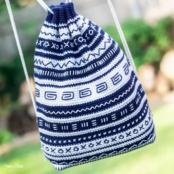A navy and white mudcloth inspired crochet backpack.