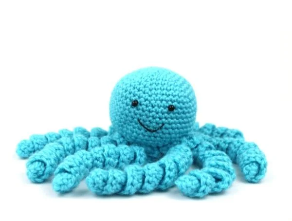 A small blue crochet octopus amigurumi.