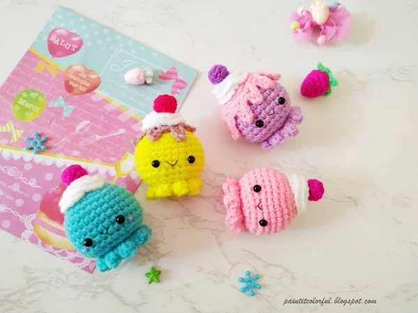Four cupcake-themed crochet octopus in different colours.