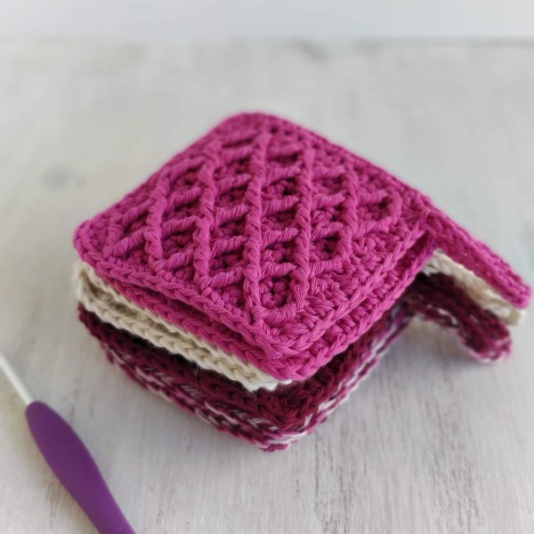 A stack of square crochet makeup remover pads.
