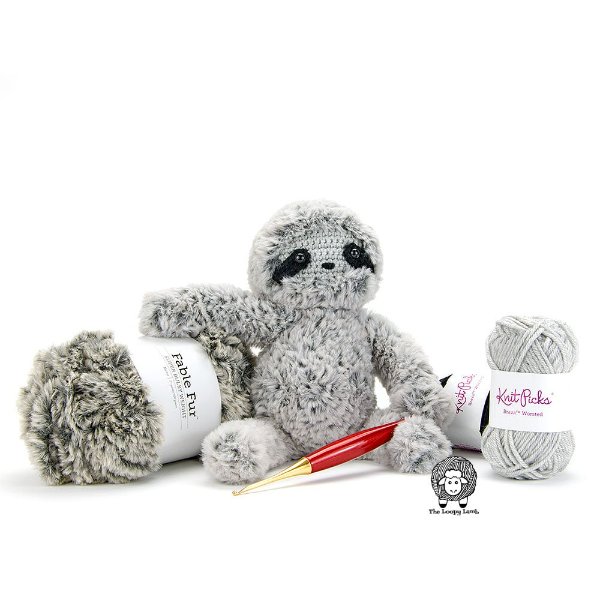 A grey crochet sloth amde in faux fur yarn.