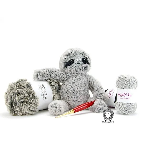 A grey crochet sloth amde in faux fur yarn.