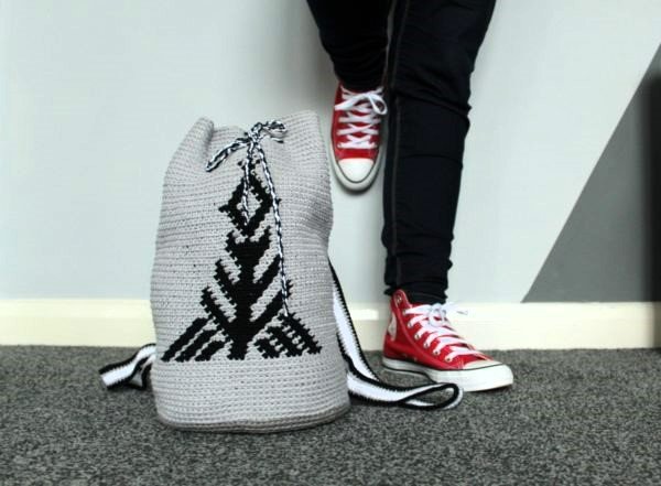 A black and white tapestry crochet backpack.
