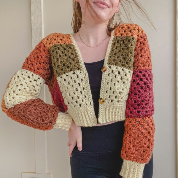 A cropped crochet granny square cardigan with a patchwork design.