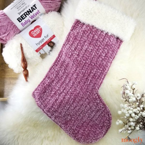 A beautiful crochet stocking worked in a pretty velvet yarn with a faux fur cuff.
