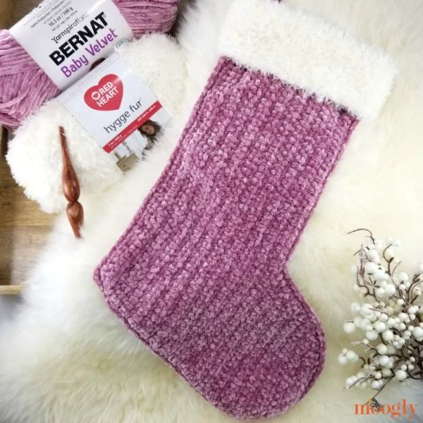 A beautiful crochet stocking worked in a pretty velvet yarn with a faux fur cuff.