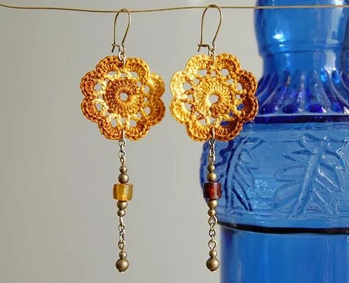 Long, dangly crochet flower earrings with beads.
