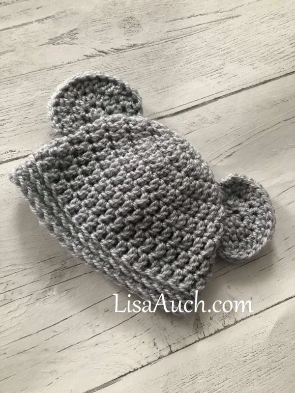 A newborn crochet hat with little bear ears.