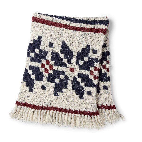 A beautiful c2c christmas blanket with a nordic-inspired snowflake motif.