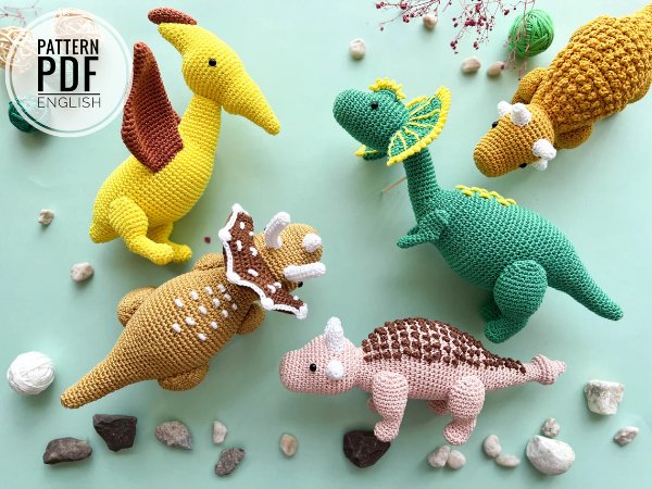 Five beautifully made crochet dinosaurs, all different types.