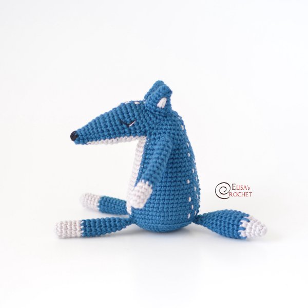 A blue and white crochet wolf toy.