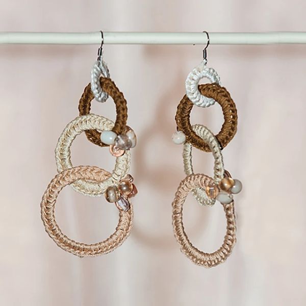 A pair of crochet earrings made with interlinking hoops.