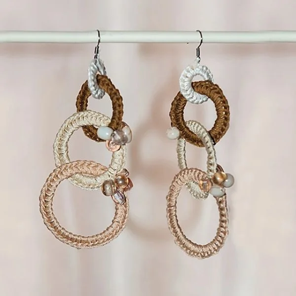 A pair of crochet earrings made with interlinking hoops.