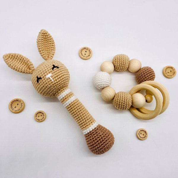 A cute crochet bunny rattle and a crochet teehing ring with wooden beads.