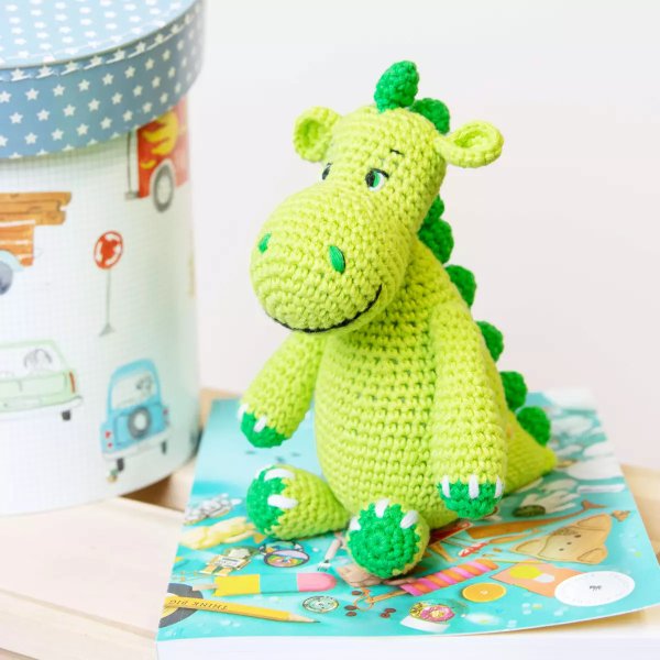 A cute crochet dinosaur made in bright greens.