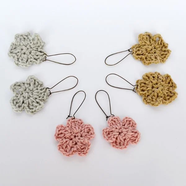 Three pair of crochet flower earrings in different colours.