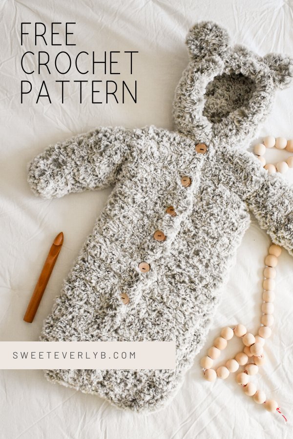A faux fur crochet baby bunting with a bear-ear hood.