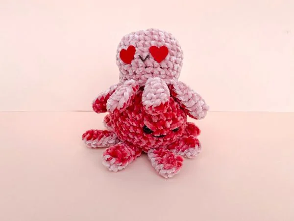 Two reversible moody crochet octopi.
