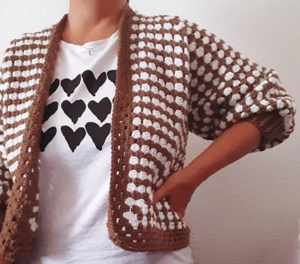 Striped hexagon crochet cardigan with a cropped length and three-quarter sleeves.