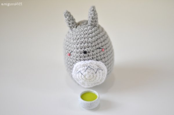 A small grey and white crochet Totoro amigurumi.