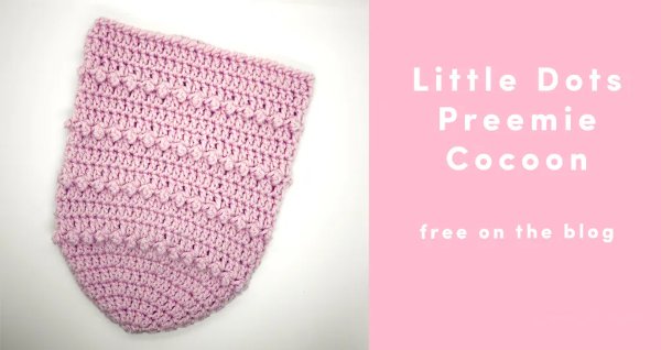 A pink crochet baby cocoon.
