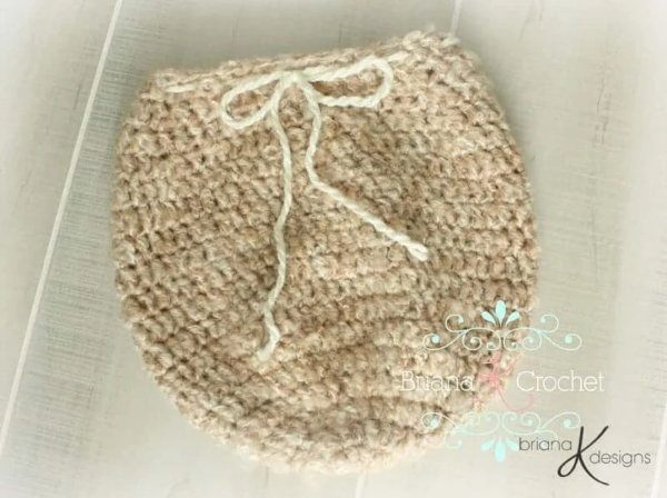 A closeup image of a newborn crochet swaddle sack for photo props.