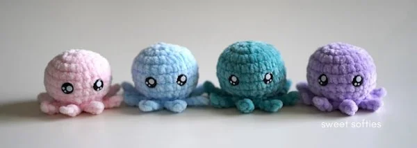 Four mini crochet octopus in a row.