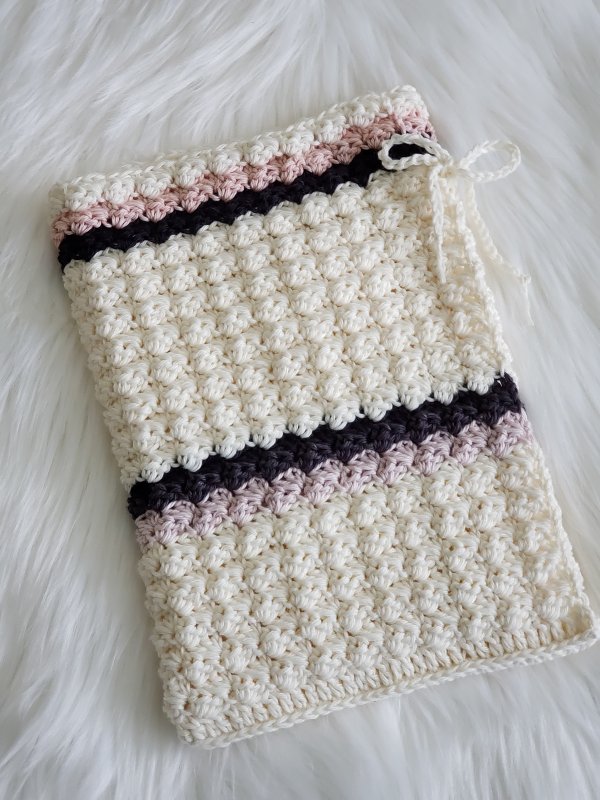 A simple crochet baby cocoon with stripes.