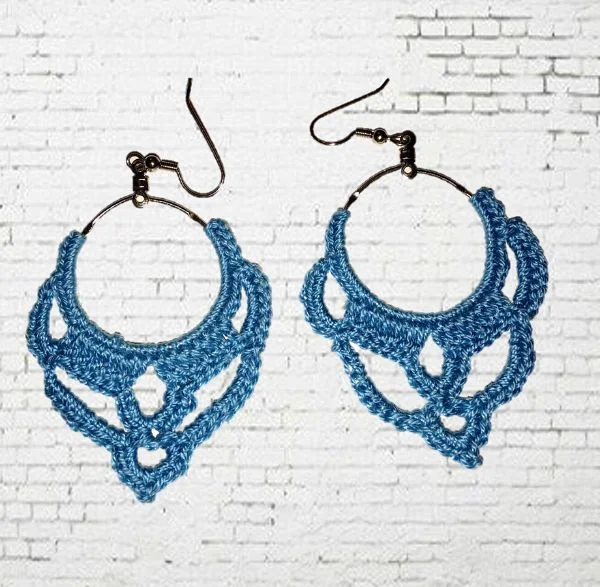 Pretty blue crochet hoop earrings on a white background.