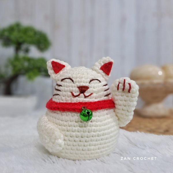 A crocheted Lucky Cat.