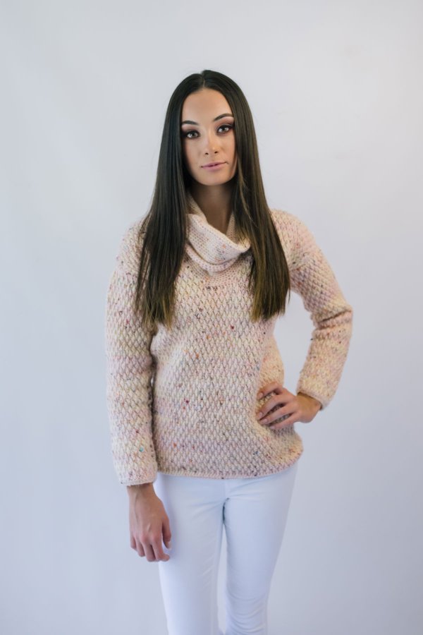 A womna wearing a relaxed, cowl-neck crochet sweater.