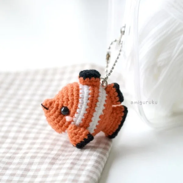 A crochet clownfish keychain.