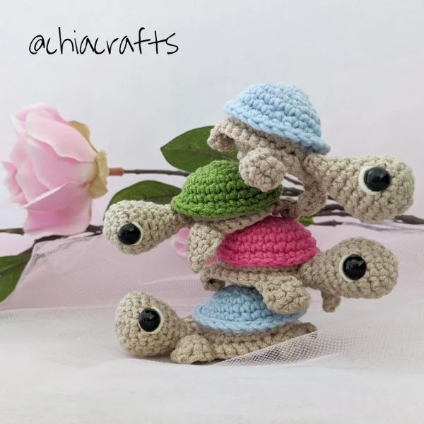 A stack of small amigurumi crochet turtles.