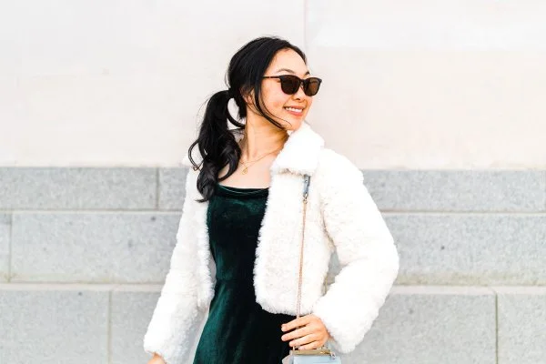 Woman wearing a faux fur cropped crochet jacket.